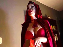 Mysterious redhead mistress teasing with strapon dildo