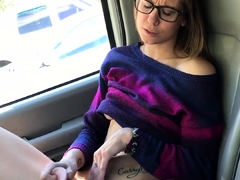 Nerdy young brunette fucks herself with a dildo in the car